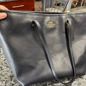 Navy coach purse.